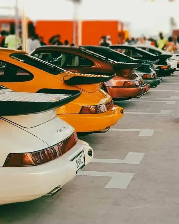 a row of parked cars sitting next to each other